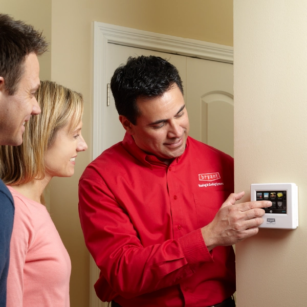 tech touching Thermostat