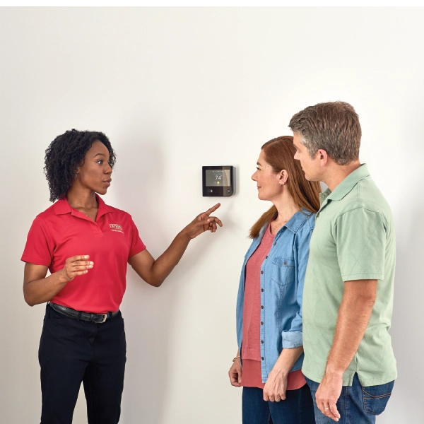 tech talking to client about Thermostat