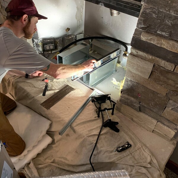 tech working with fireplace